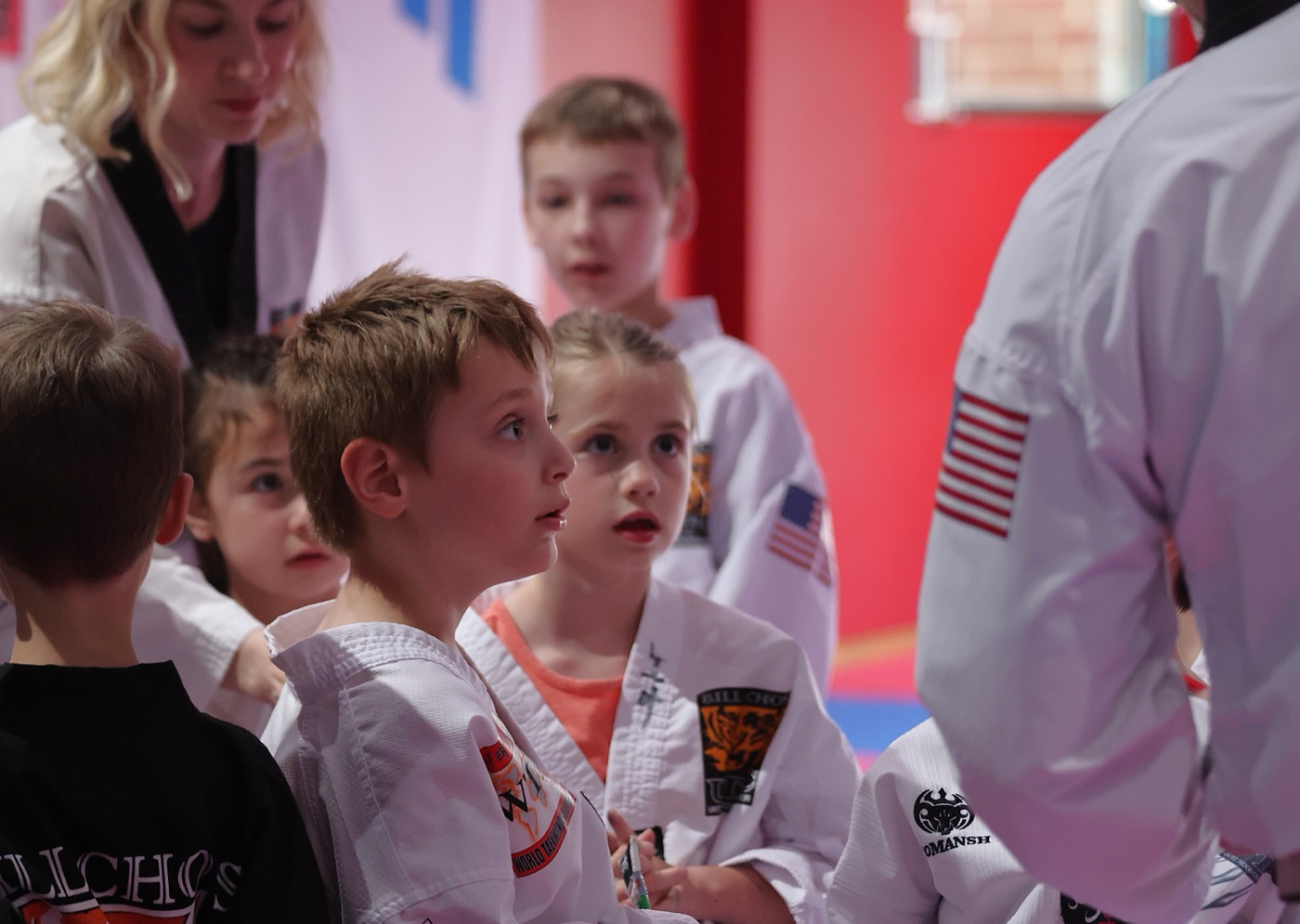 Kids at Bill Cho's looking up attentively to their instructor